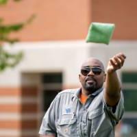 A staff member throws a bag during the tournament